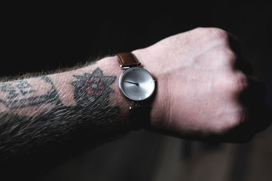 NordgreenUniqa with silver face and brown leather watch strap on wrist